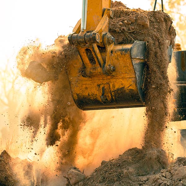 Large Excavator-Bucket of Dirt | The Wellons Group